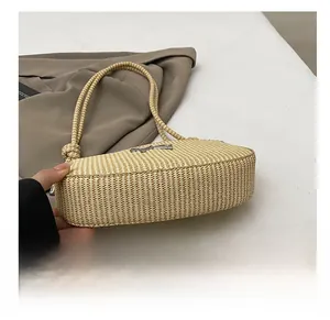 Detail shot of woven bow shoulder bag showing the durable rounded base and texture