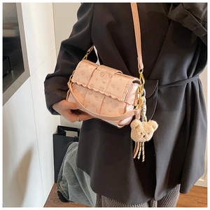 Détail d'un mini sac tissé rose avec motifs d'ours et chaîne en métal doré