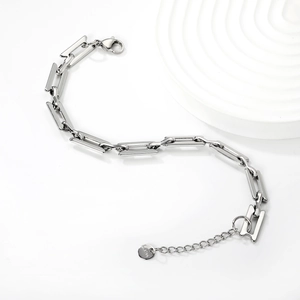 Macro detail of silver stainless steel chain bracelet with S.Steel engraved tag