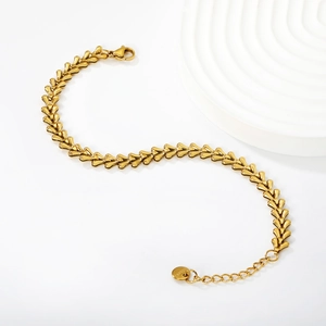 Minimalist gold stainless steel Cuban link bracelet with heart-shaped links on white background