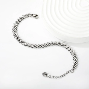 Detailed view of silver stainless steel twisted heart chain bracelet with lobster clasp