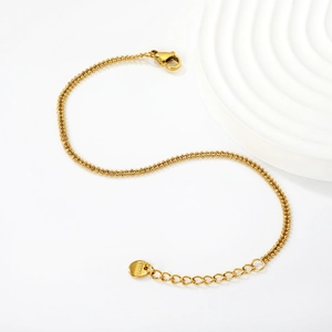 Detailed macro of golden double-layer stainless steel bead chain with lobster clasp