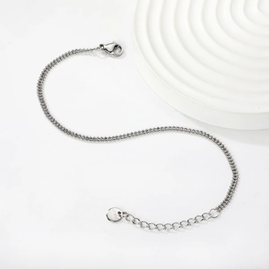 Detail of silver stainless steel double beaded chain with lobster clasp and S.Steel tag