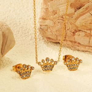 Golden crown jewelry set with white zircon necklace and stud earrings on natural stone