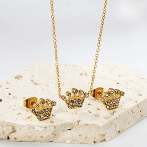 Detailed view of gold crown jewelry set with sparkling cubic zirconia on a stone stand