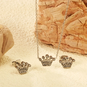 Detail of silver crown jewelry set with white cubic zirconia on natural rock base