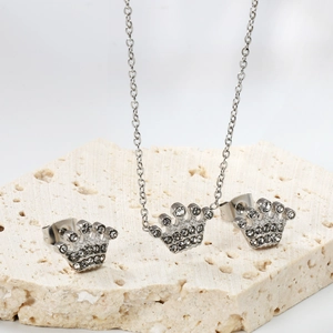 Macro shot of silver crown jewelry set with sparkling white crystals on stone display