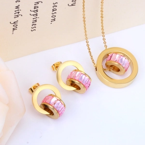 Golden stainless steel jewelry set featuring pink crystal circle pendant and matching studs