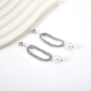 Close-up of double layer silver bead chain earrings with white teardrop pearl accents