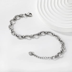 Detailed macro view of silver stainless steel thick link chain bracelet with lobster clasp