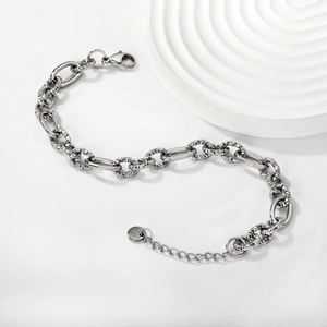 Detail of silver stainless steel chain bracelet with smooth and textured oval link design