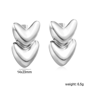 Macro shot of silver double heart stud earrings in polished stainless steel finish
