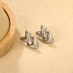 Polished silver double heart stud earrings with layered design for a stylish 3D look