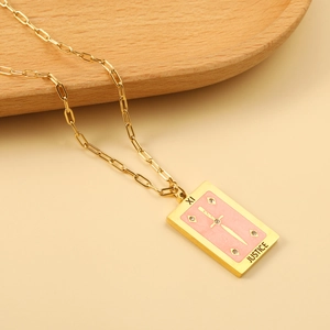 Macro detail of Justice tarot card pendant with pink enamel and sparkling crystals