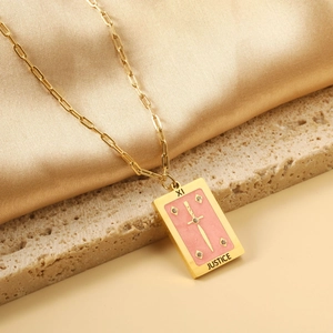 Detail of gold rectangular Justice Tarot pendant with sword and pink enamel background