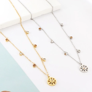 Close-up of gold and silver necklaces with hollow wheel pendants and inlaid zircons