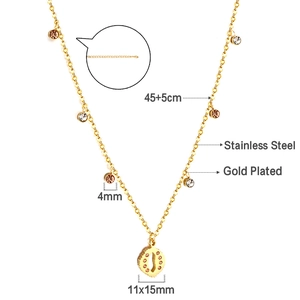 Detail of gold plated stainless steel necklace featuring a textured circular pendant
