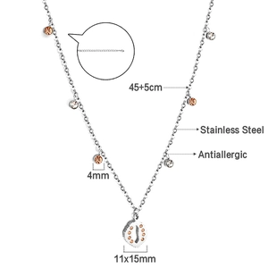 Detail view of stainless steel necklace with crystal accents and cutout oval pendant