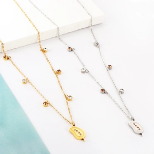 Minimalist gold and silver leaf necklaces with round diamonds on marble background