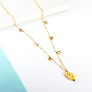 Detail of gold mango pendant necklace with inlaid crystals and round rhinestone chain