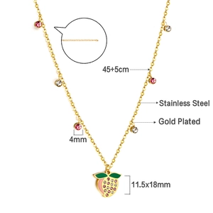 Detail of gold plated stainless steel necklace featuring fruit pendant and cubic zirconia