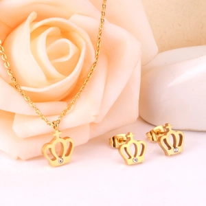 Detailed view of gold crown jewelry set with sparkling rhinestones and rose decor