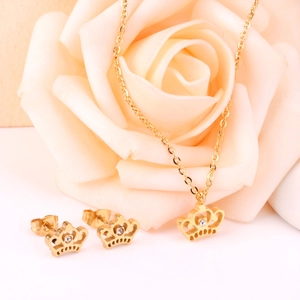 Elegant gold stainless steel jewelry set featuring a crown necklace and stud earrings