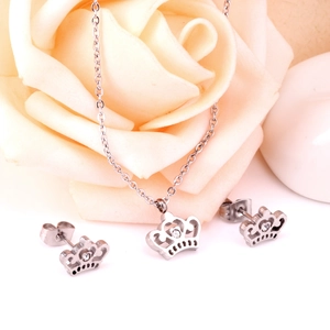 Detailed view of crown pendant necklace and stud earrings set with sparkling crystals