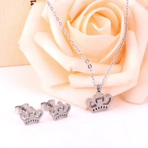 Detailed crown jewelry set with sparkling necklace and earrings on rose background