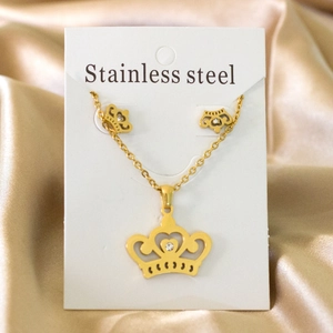 Golden stainless steel jewelry set featuring crown pendants with sparkling crystals