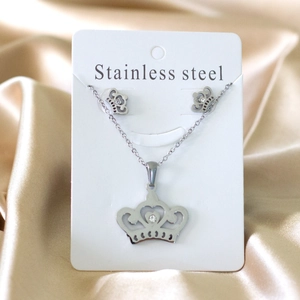 Detailed close-up of crown jewelry set with sparkling rhinestones on champagne silk