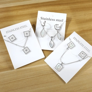 Modern stainless steel jewelry set featuring square butterfly earrings and necklace charm