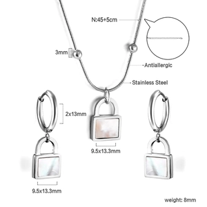 Detail view of square white shell pendant on stainless steel necklace and earring set