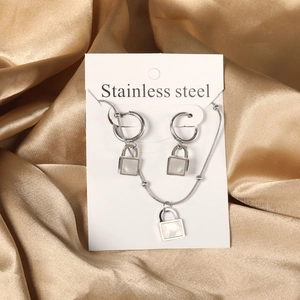 Silver stainless steel jewelry set with square white shell pendants on gold satin