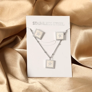 Detailed close-up of stainless steel square white shell star pendant necklace and earrings