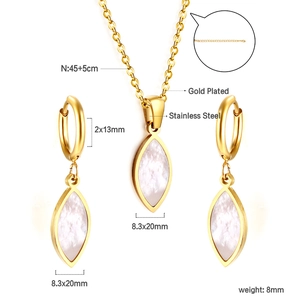 Detail view of gold-plated stainless steel jewelry set with white shell butterfly motifs