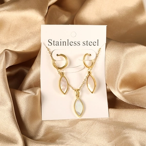 Detail of gold stainless steel necklace and hoop earrings with white shell inlays