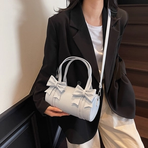Light blue cylinder pillow bag with decorative bows and adjustable shoulder strap style