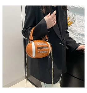 Detail of creative rugby shaped PU handbag with metal chain strap and logo lettering