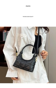 Detailed close-up of a black quilted crossbody bag with gold metal hooks and luxury texture