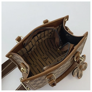 Detail view of large tote bag interior showing striped lining and zipper pocket