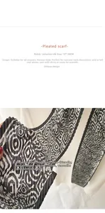 Detailed view of black and white pleated silk scarf with abstract geometric pattern