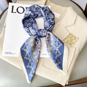Blue and beige floral silk square scarf elegantly styled on a beige blazer jacket