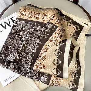 Detailed view of 70x70 square silk scarf with floral paisley print and silky texture