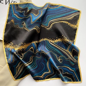 Detailed view of square silk scarf featuring marble texture and yellow contrast edges