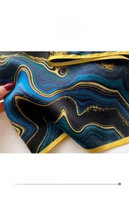 Close-up of vintage floral silk scarf with gold edges and fine stitching details