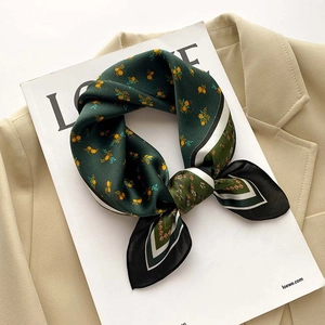 Vintage floral silk scarf with aurora print and striped borders on a beige blazer