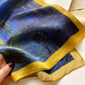 Close-up of silk scarf with Van Gogh star oil painting print and yellow border