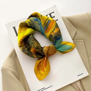 Detailed view of yellow floral oil painting silk scarf on a stylish fashion magazine