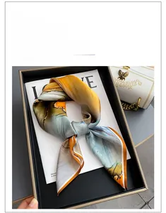 Détail du foulard en soie avec texture abstraite orange et bleue et bordures roulottées